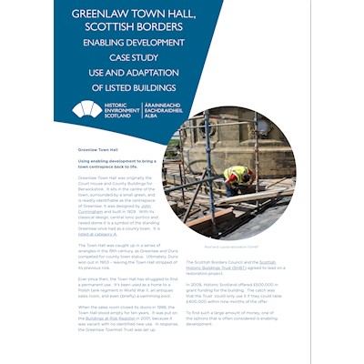 Front cover of case study about Greenlaw Townhall where a man can be seen renovating the Townhall.