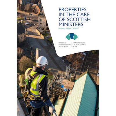A photograph of a man in a high visibility jacket, looking over scaffolding to the roof of a building. The title is "Properties in the Care of Scottish Ministers: Annual Report 2016-17"