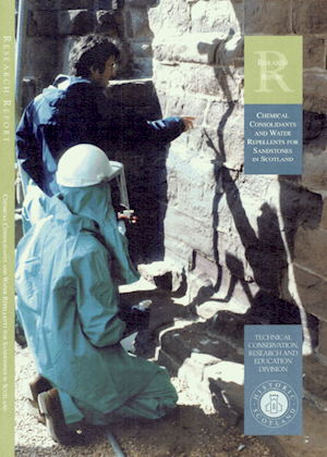 Cover page with two members of staff carrying out conservation work on a sandstone building