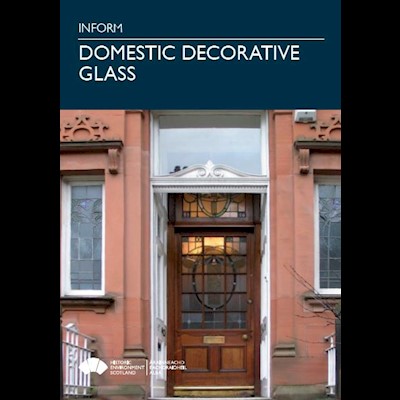 Cover page with a photo of a sandstone building with a decorative glass door