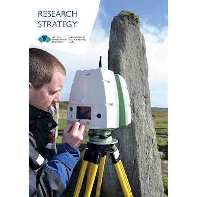 HES employee scanning a standing stone