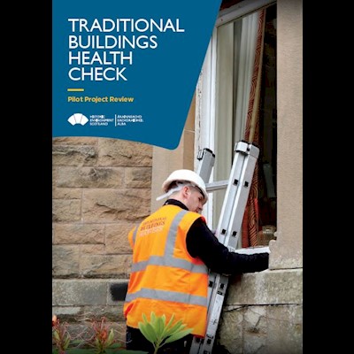 A cover page featuring a person up a ladder inspecting an older building's window